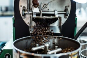 Coffee beans being ground close up in a burr grinder
