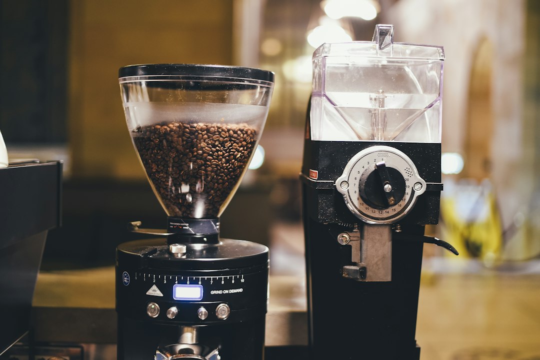 A coffee grinder machine grinding fresh coffee beans